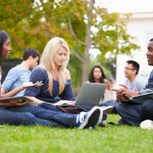 Student group on lawn at college studying represents Industries We Serve at Tomorrow Future Consulting